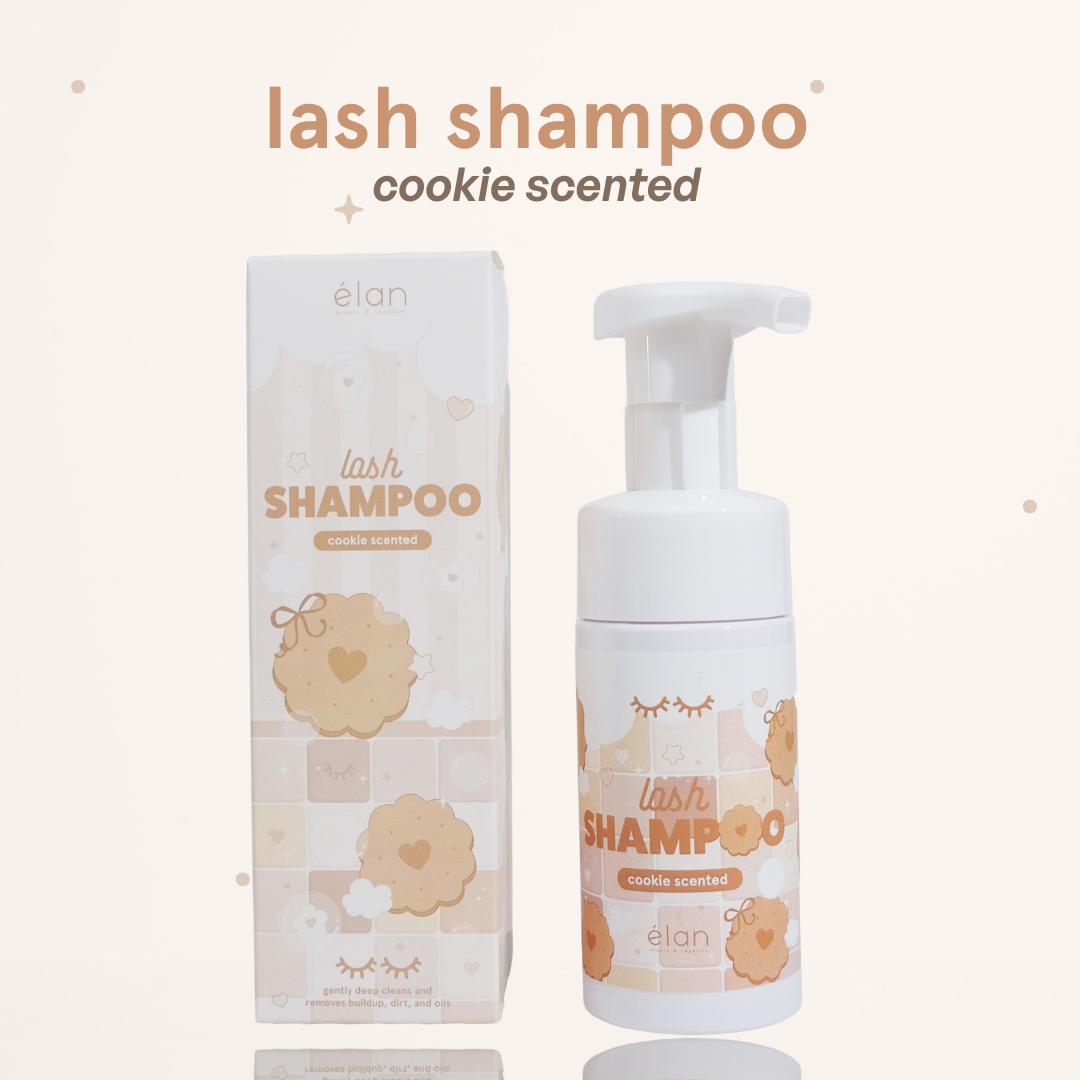 Cookie scented lash shampoo in a foaming pump container next to its cookie-themed packaging.