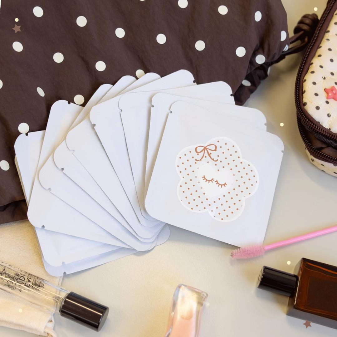 Shampoo packets with white and brown polka dots on its packaging surrounded by polka dot themed bags.