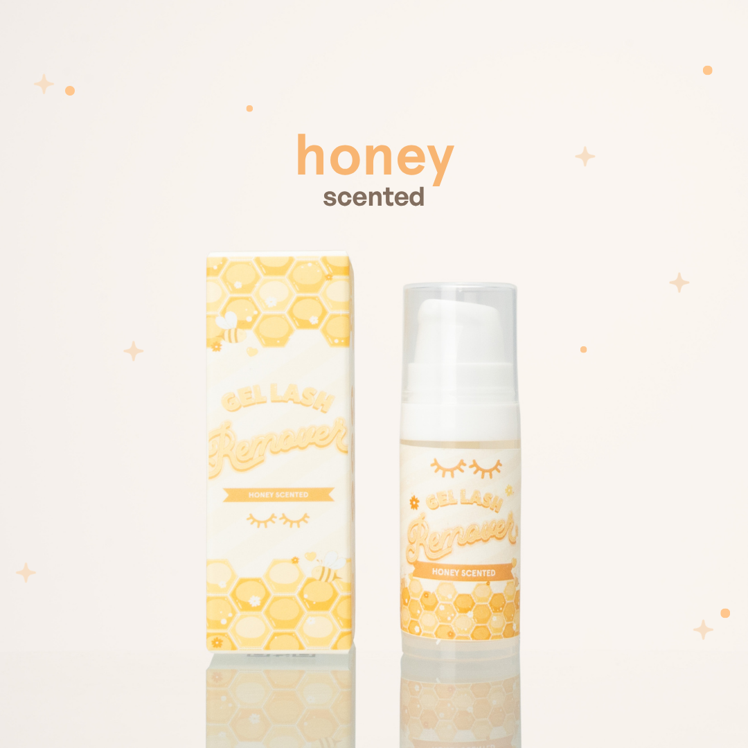 Honey scented gel lash remover beside its yellow and white packaging with honeycomb illustrations on it.