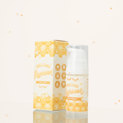 Honey scented gel lash remover beside its yellow and white packaging with honeycomb illustrations on it.