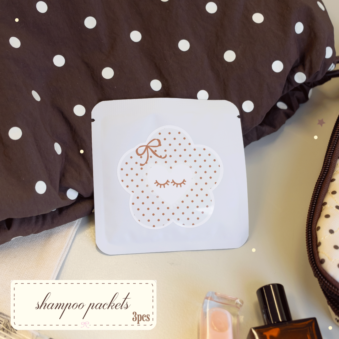 3 piece Shampoo packets with white and brown polka dots on its packaging surrounded by polka dot themed bags.