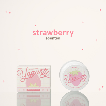 Strawberry scented yogurty lash remover beside its red pink and white packaging.