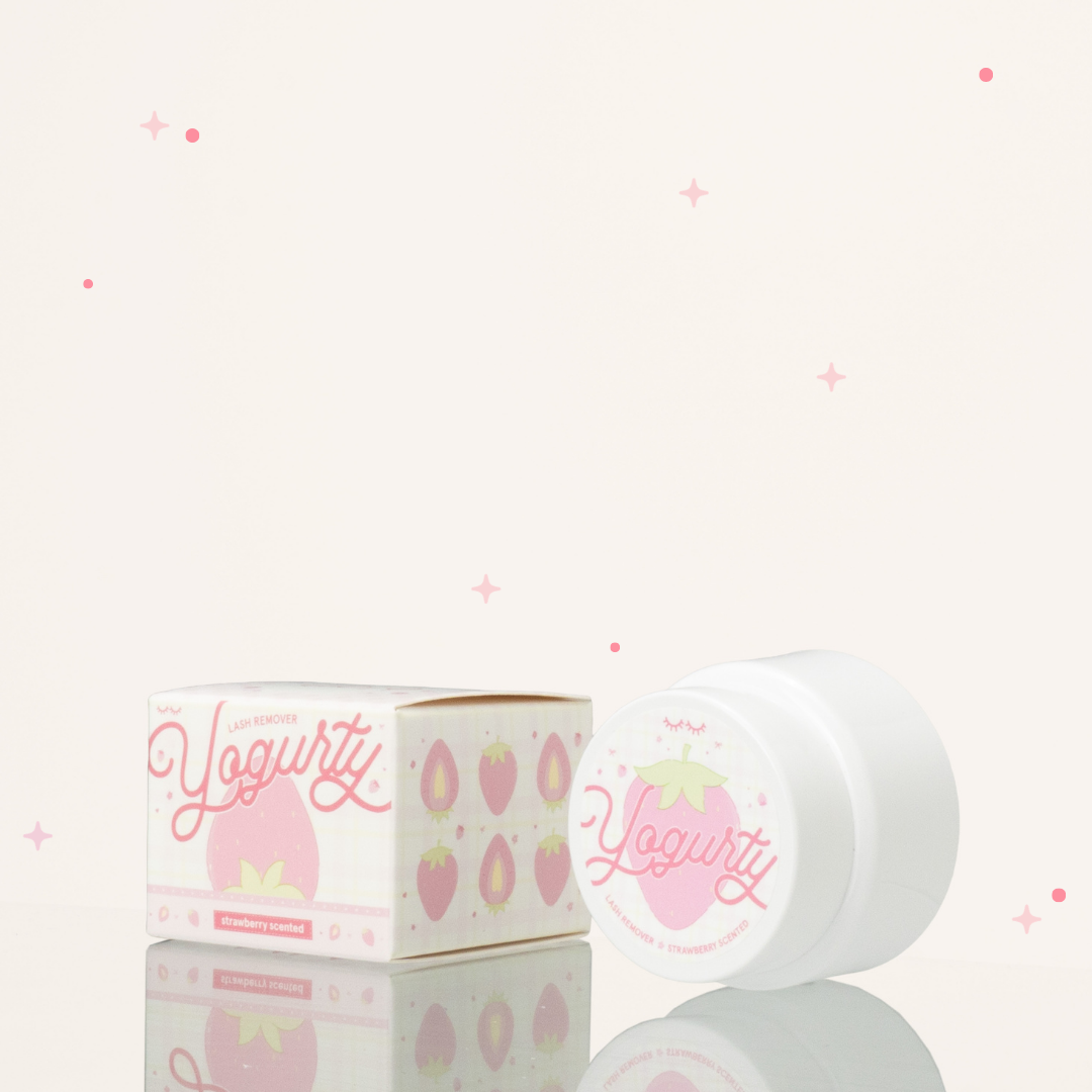 Side view of strawberry scented yogurty lash remover beside its red pink and white packaging.