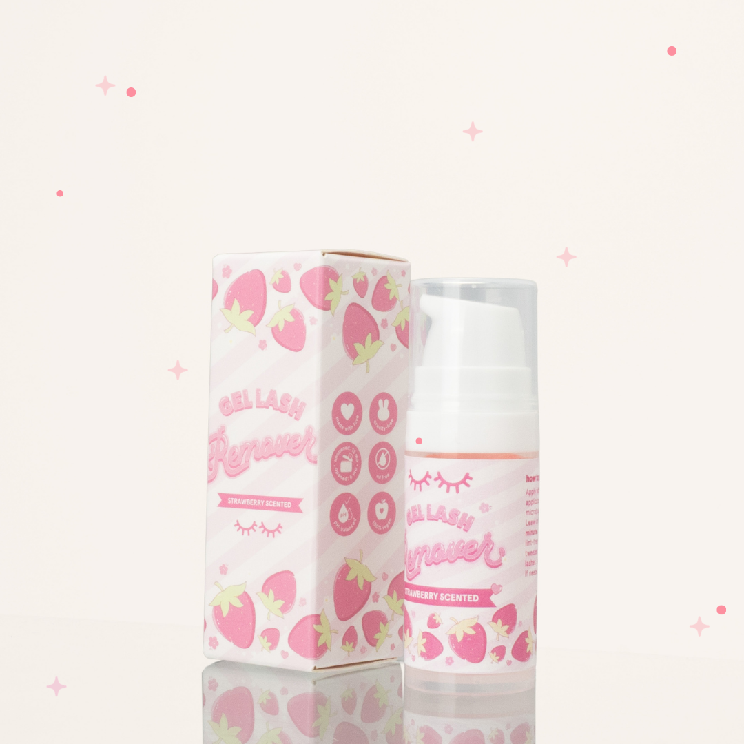 Side view of strawberry scented gel lash remover beside its pink and white packaging.