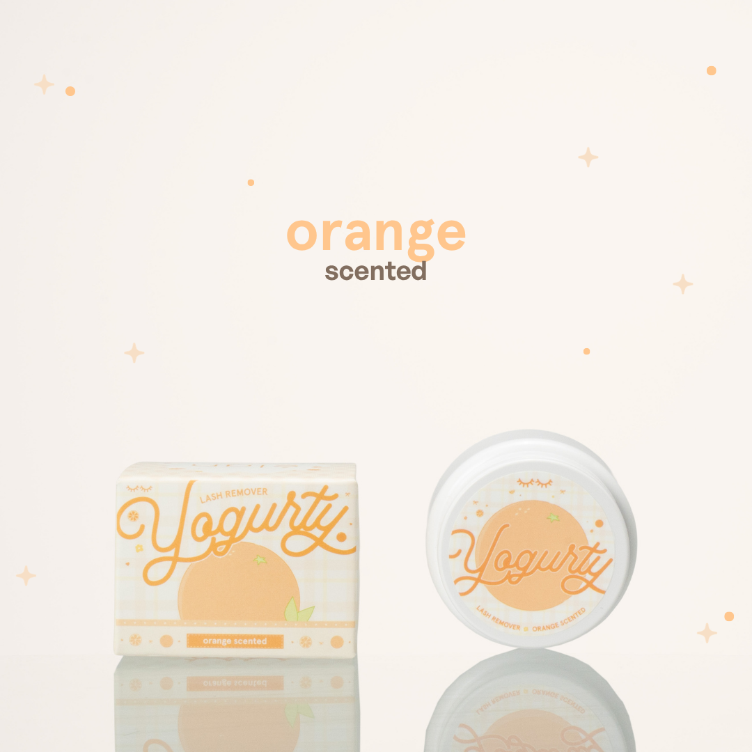Orange scented yogurty lash remover beside its orange-and-white packaging.