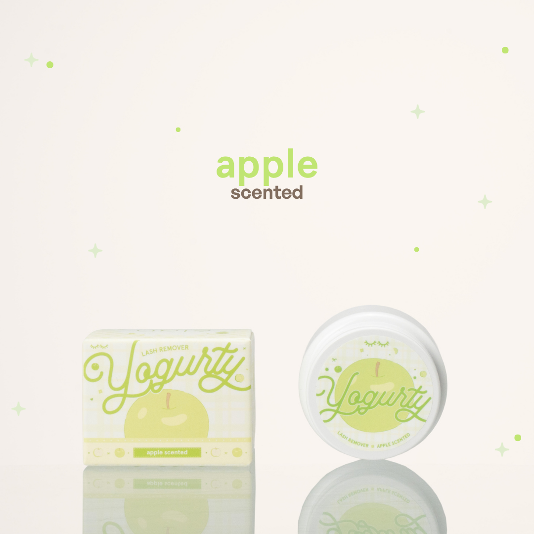 Apple scented yogurty lash remover beside its green-and-white packaging.