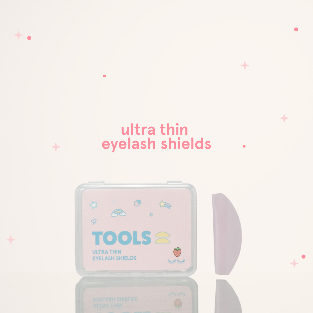 Ultra thin eyelash shields next to its pink and clear packaging with text that says "Tools" 