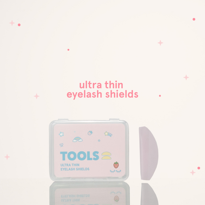 Ultra thin eyelash shields next to its pink and clear packaging with text that says "Tools" 
