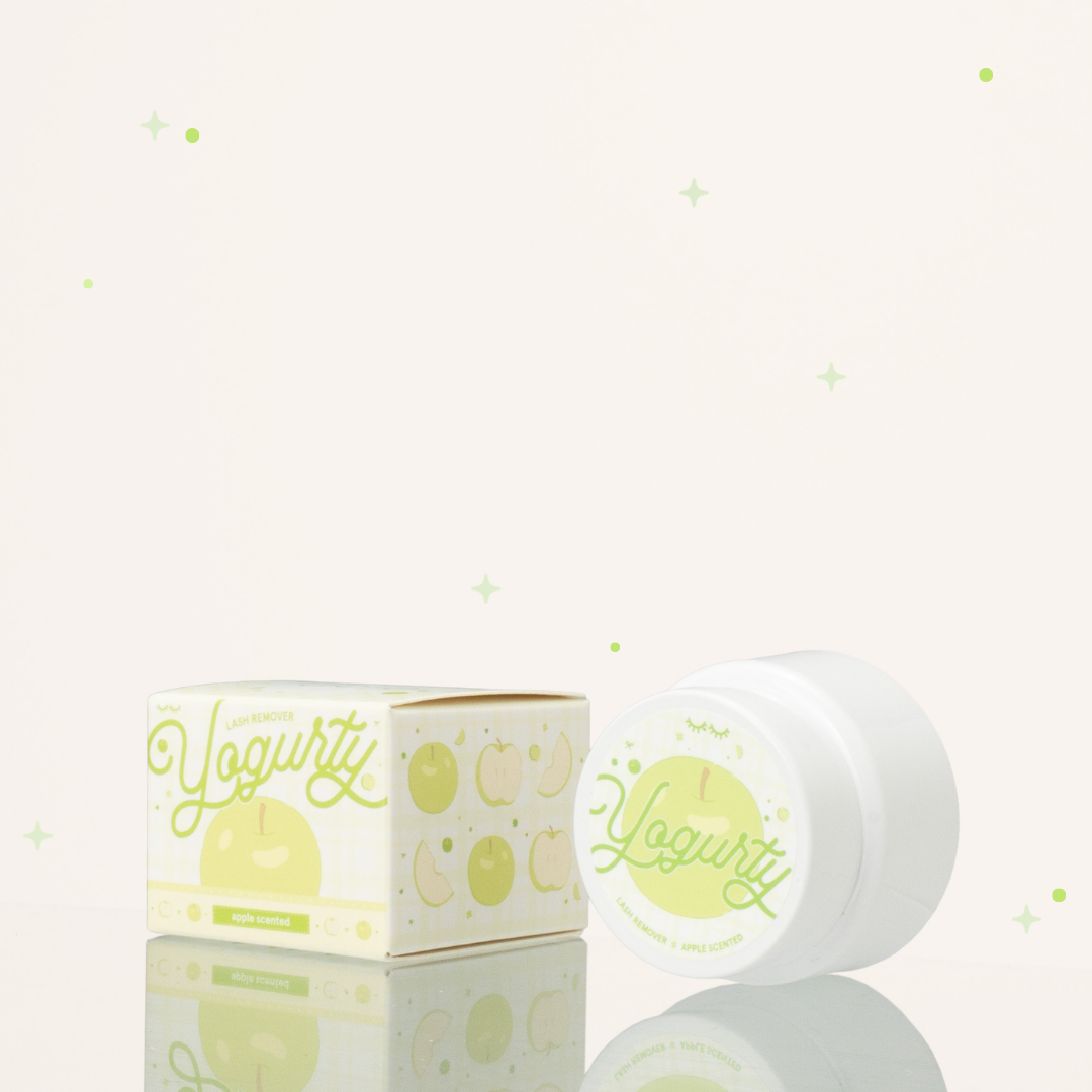 Side view of apple scented yogurty lash remover beside its green-and-white packaging.