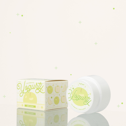 Side view of apple scented yogurty lash remover beside its green-and-white packaging.