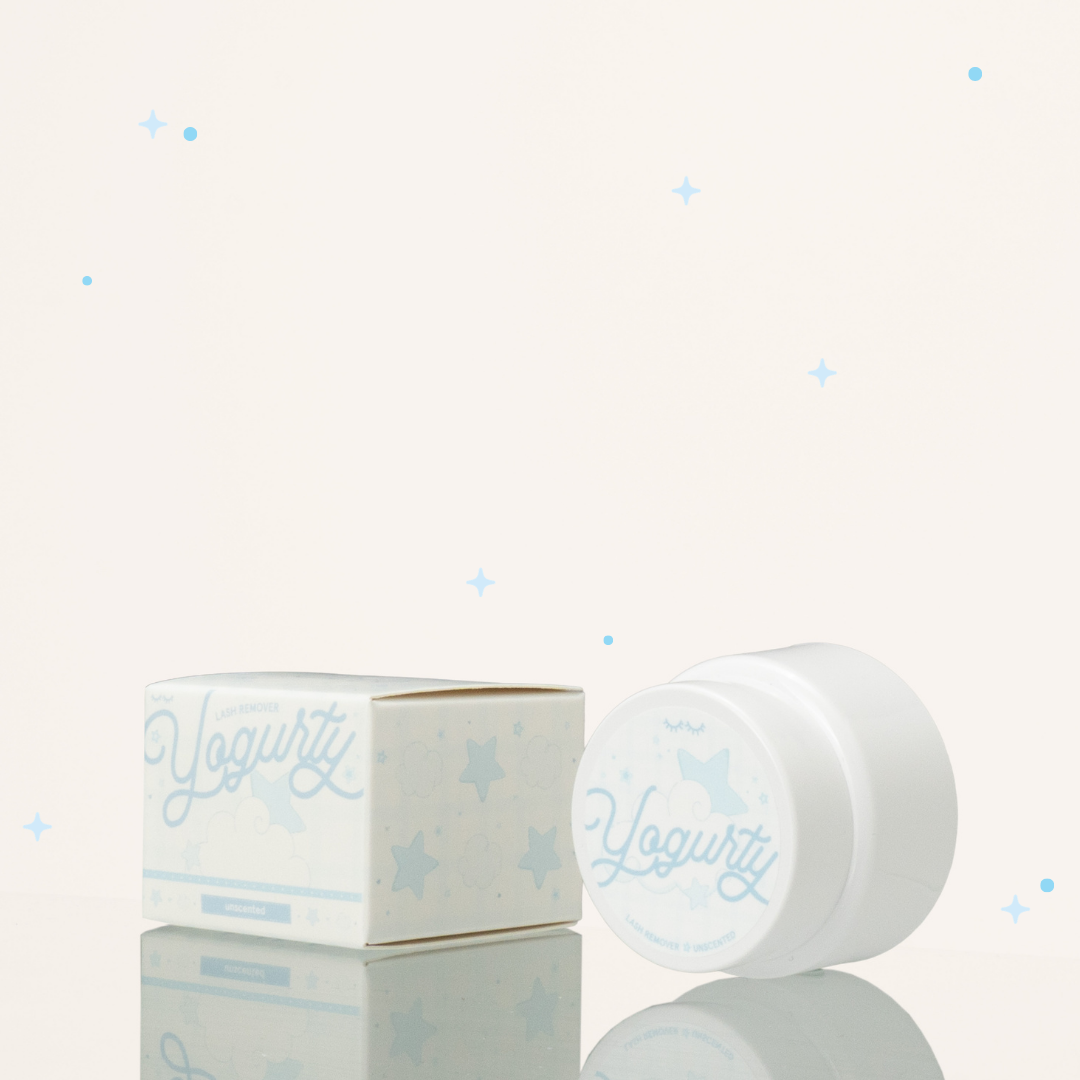 Side view of unscented yogurty lash remover beside its blue-and-white packaging.