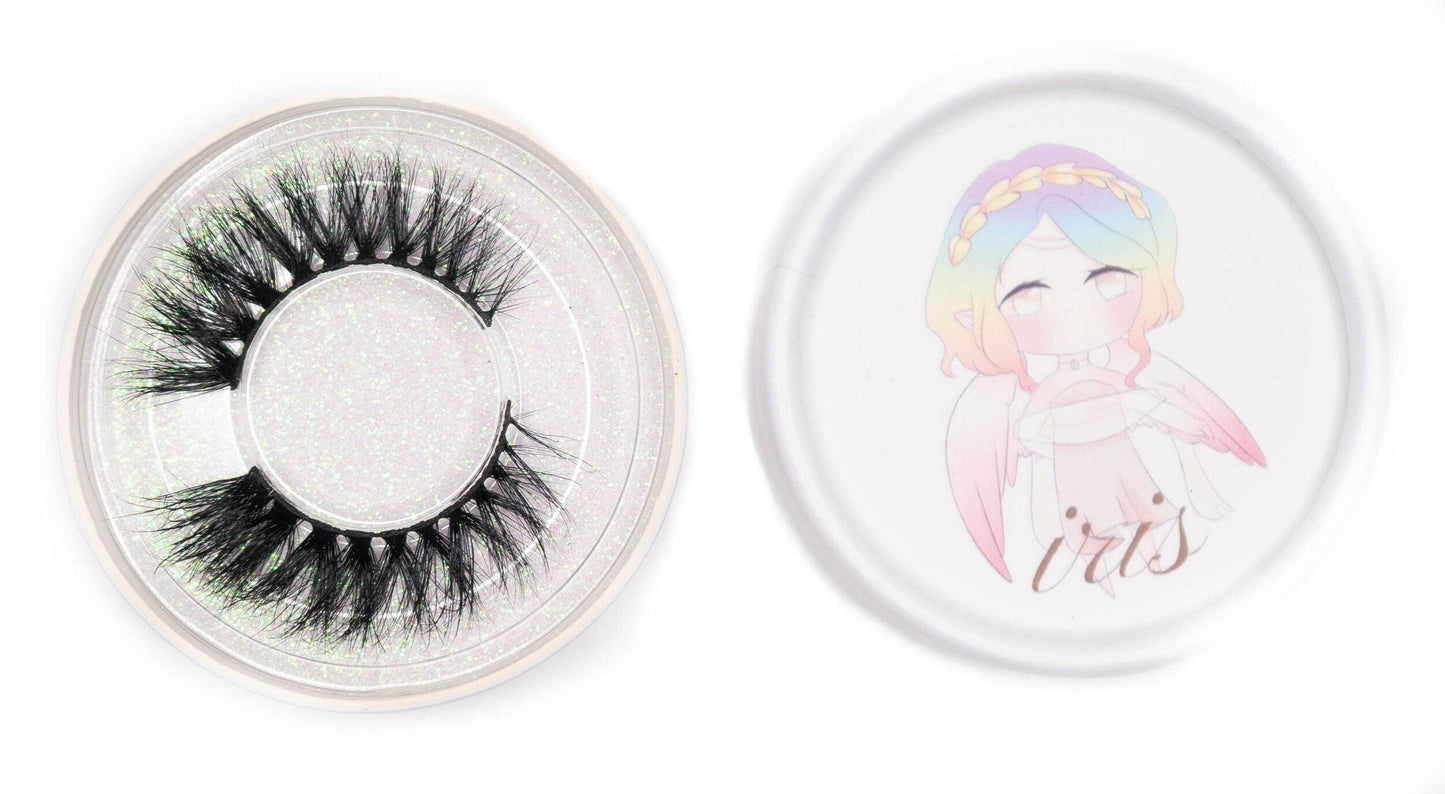 Iris false eyelashes in a clear round case beside the illustrated Iris product lid on a white background.