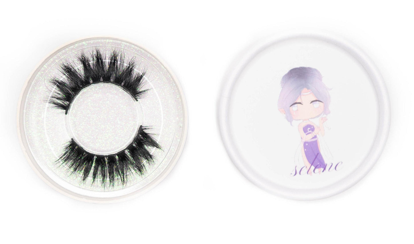Selene false eyelashes in a clear round case beside the illustrated Selene product lid on a white background.