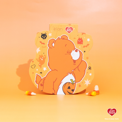 Élan Beauté x Care Bears Halloween packaging featuring an orange Care Bear with a jack-o’-lantern on an orange background.