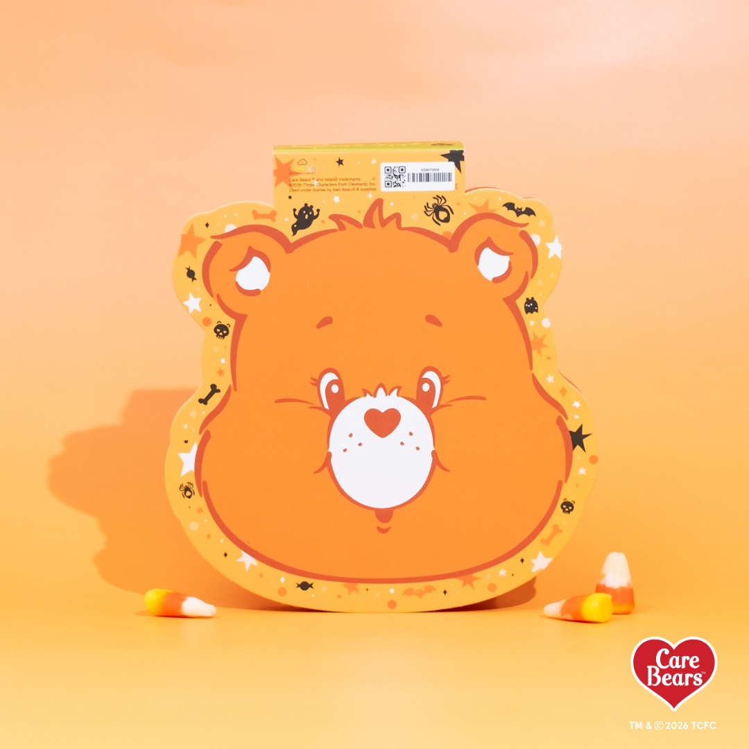 Élan Beauté x Care Bears Halloween packaging featuring an orange Care Bear on an orange background with candy corn around the packaging.