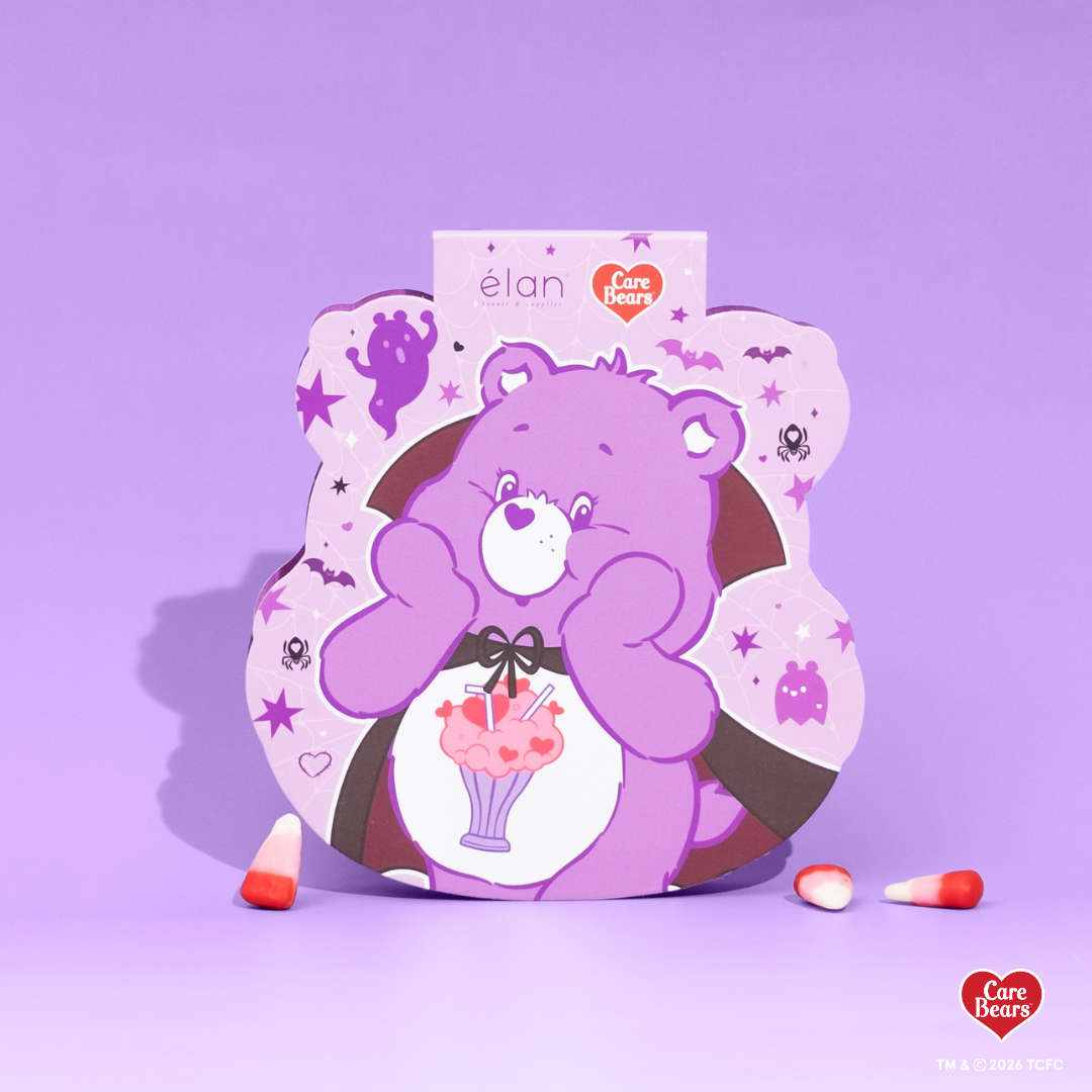 Élan Beauté x Care Bears Share Bear purple Big Boi lash tray in purple Halloween-themed Care Bears packaging with candy corn accents.