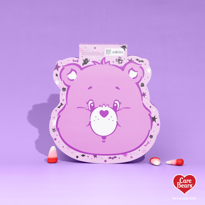 Élan Beauté x Care Bears Share Bear purple Big Boi lash tray in purple Halloween-themed Care Bears packaging with candy corn accents.
