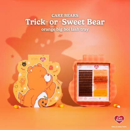 Élan Beauté x Care Bears Trick-or-Sweet Bear orange Big Boi lash tray featuring warm brown and orange specialty lashes in Halloween-themed Care Bears packaging with candy corn accents.