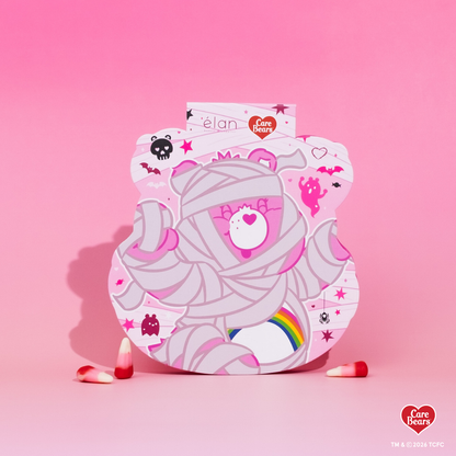 Élan Beauté x Care Bears Cheer Bear Big Boi lash tray in pink Halloween-themed Care Bears packaging with candy corn accents.