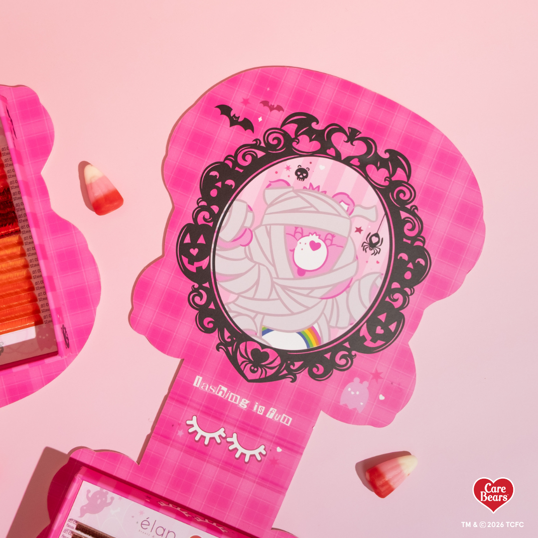Élan Beauté x Care Bears Cheer Bear Big Boi lash tray in pink Halloween-themed Care Bears packaging with candy corn accents.