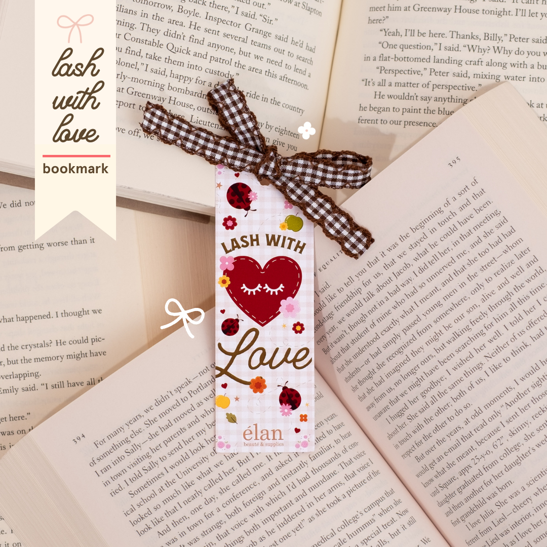 “Lash With Love” bookmark featuring a red heart with eyelash graphics, ladybugs, flowers, and a brown gingham ribbon, styled on top of open book pages.