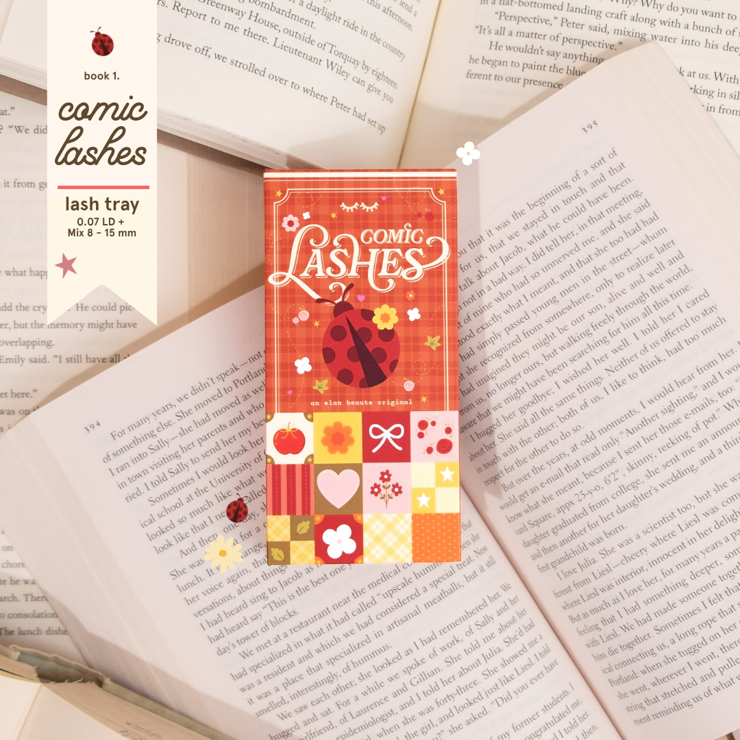 Comic Lashes tray with red and cream book-inspired packaging, placed on top of open book pages with floral and ladybug details.