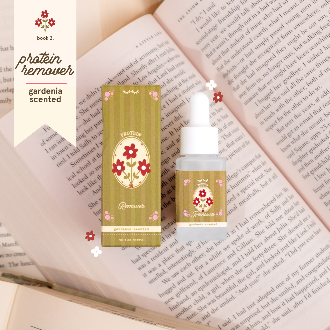 Gardenia-scented protein remover in olive green floral packaging with a matching dropper bottle, styled on top of open book pages.