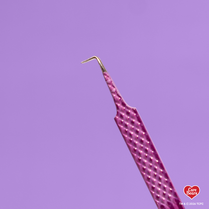 Élan Beauté x Care Bears purple volume tweezer featuring a textured grip and skinny 90-degree angled tip, shown against a purple background.