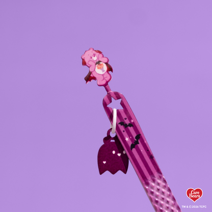 Élan Beauté x Care Bears e03 volume tweezer featuring a skinny 90-degree tip and a purple Halloween-themed design with a purple carebear.
