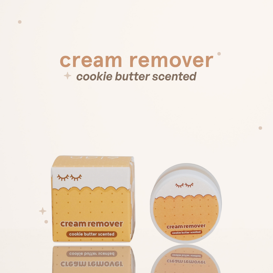 Cookie butter scented cream remover in its pot container next to its cookie themed brown-and-white packaging.