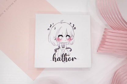 Hathor false eyelash box featuring an illustrated character on a white and pale pink background.