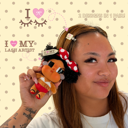 Person wearing crease-free hair clips with yellow and white polka dots and text on it saying "I Heart My Lash Artist" in pink text with text that says "2 designs in 1 pair!"