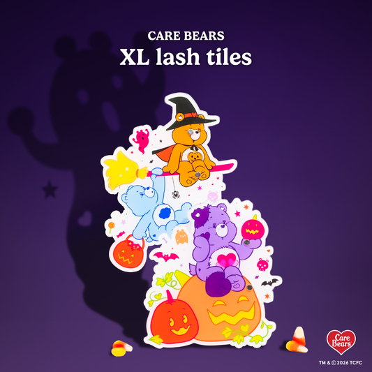 Élan Beauté x Care Bears Halloween XL lash tiles featuring colorful Care Bears characters, pumpkins, ghosts, bats, and witch-themed artwork on a dark purple background.