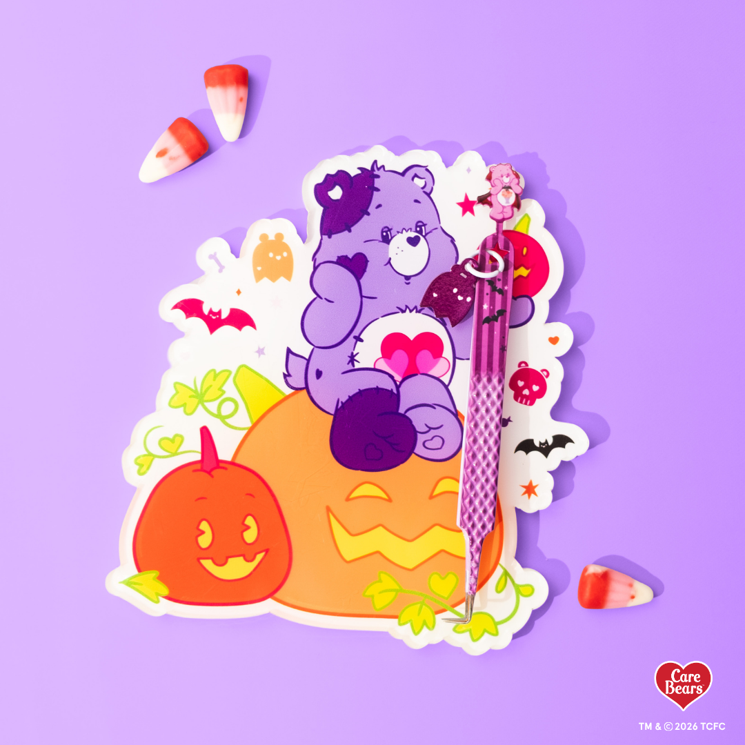 Élan Beauté x Care Bears Jack-o’-Lantern lash tile featuring a purple Care Bear sitting on orange pumpkins, surrounded by ghosts, bats, stars, and candy corn on a purple background.