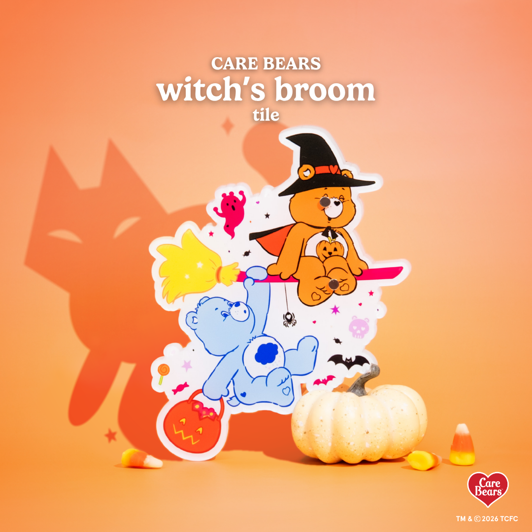 Élan Beauté x Care Bears Witch’s Broom lash tile featuring orange and blue Care Bears riding a broom, surrounded by ghosts, bats, pumpkins, candy, and Halloween accents on a warm orange background.
