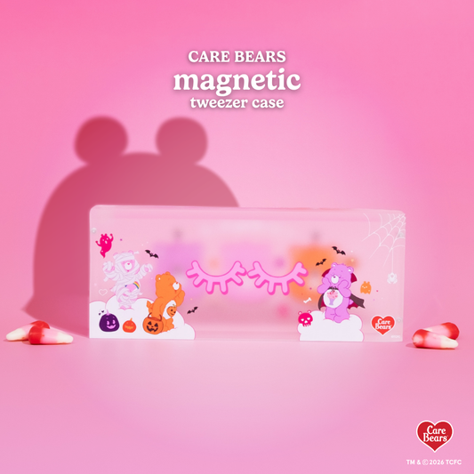 Élan Beauté x Care Bears magnetic tweezer case featuring Halloween-themed Care Bears, bats, pumpkins, spiderweb details, and eyelash graphics on a pink background.