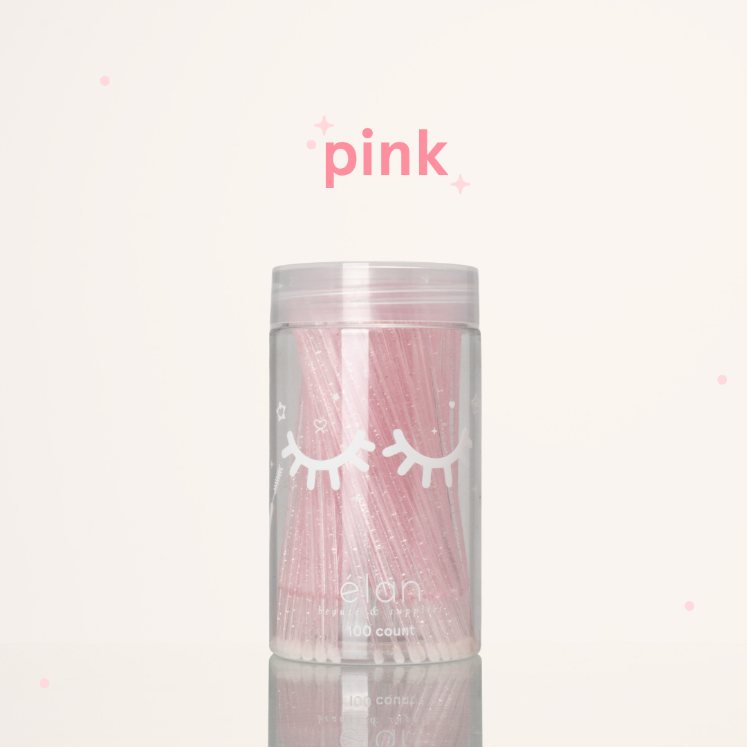 Élan Beauté pink glitter microbrush applicator brushes in a clear 100-count container with white eyelash graphics, displayed on a soft cream background with pink accents.