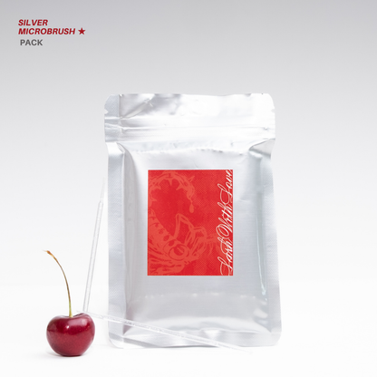 Silver Microbrush Pack in metallic silver packaging with clear microbrush applicators and a red cherry, photographed on a clean white background.