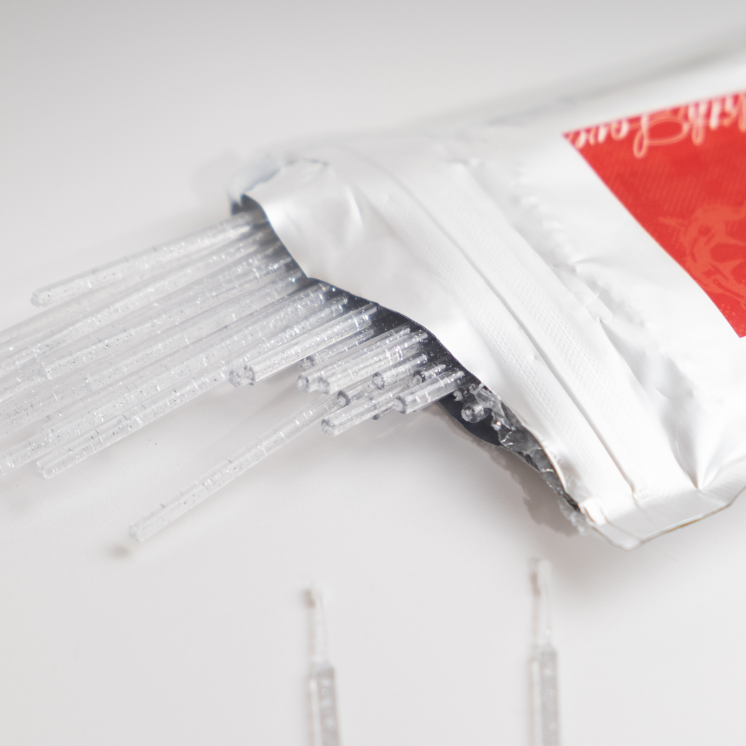 Silver Microbrush Pack in metallic silver packaging with clear microbrush applicators spilling out on a clean white background.
