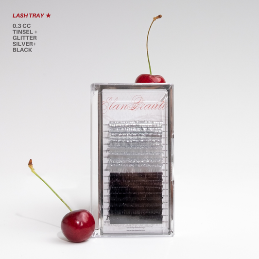 Silver tinsel, glitter, and black lash tray in 0.03 CC curl, displayed in a clear case with red cherries on a white background.