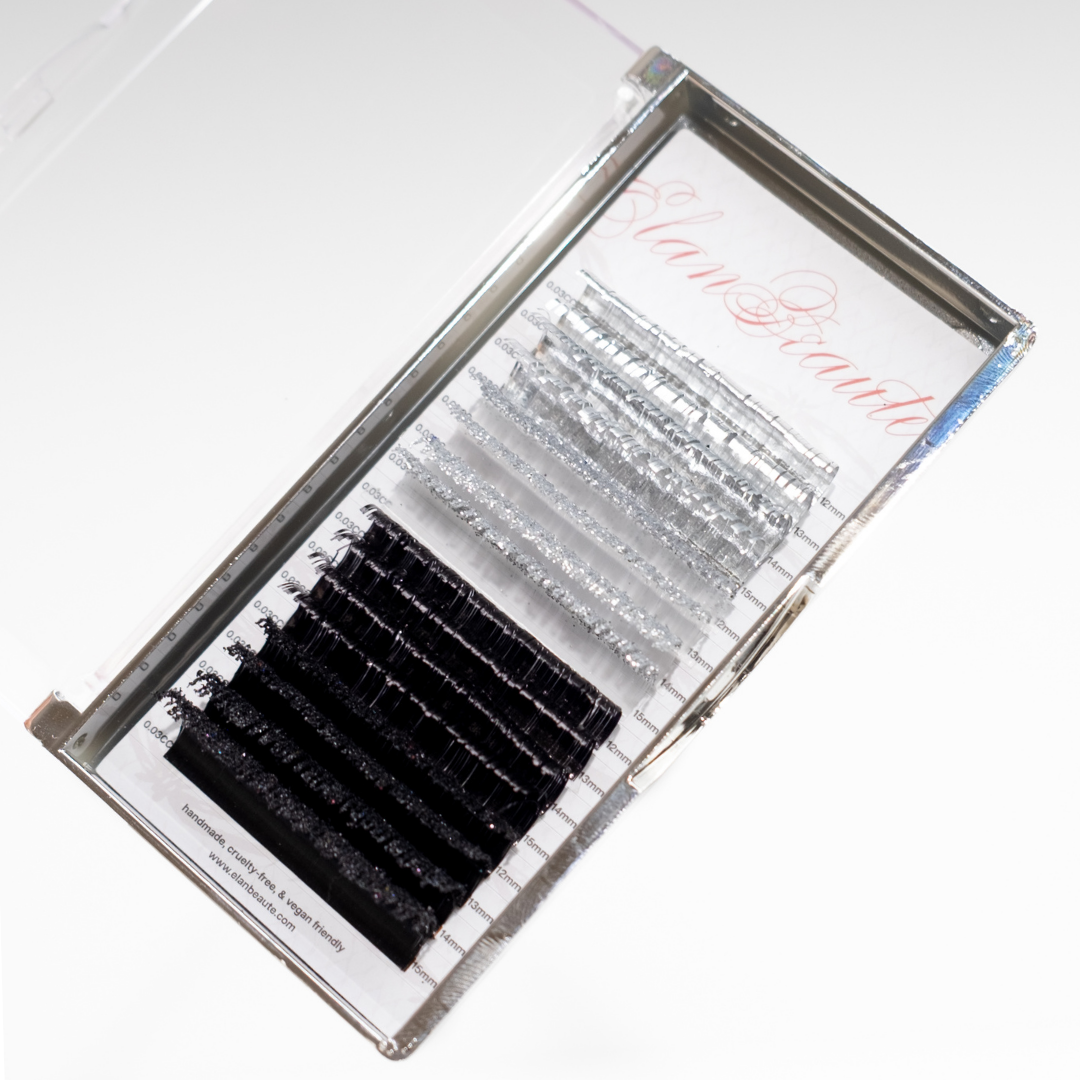 Silver tinsel, glitter, and black lash tray in 0.03 CC curl, displayed in a clear case on a white background.