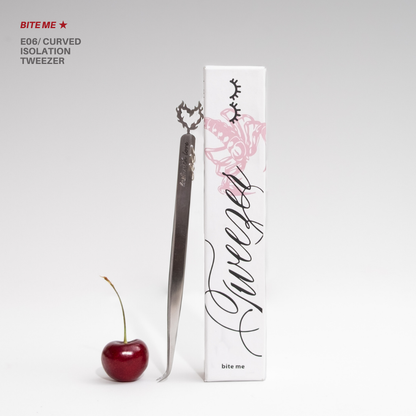 Bite Me E06 curved isolation tweezer with matching white rose-themed packaging, styled beside a red cherry on a clean white background.