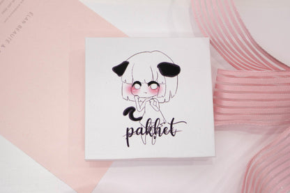 Pakhet false eyelash box featuring an illustrated character on a white and pale pink background.