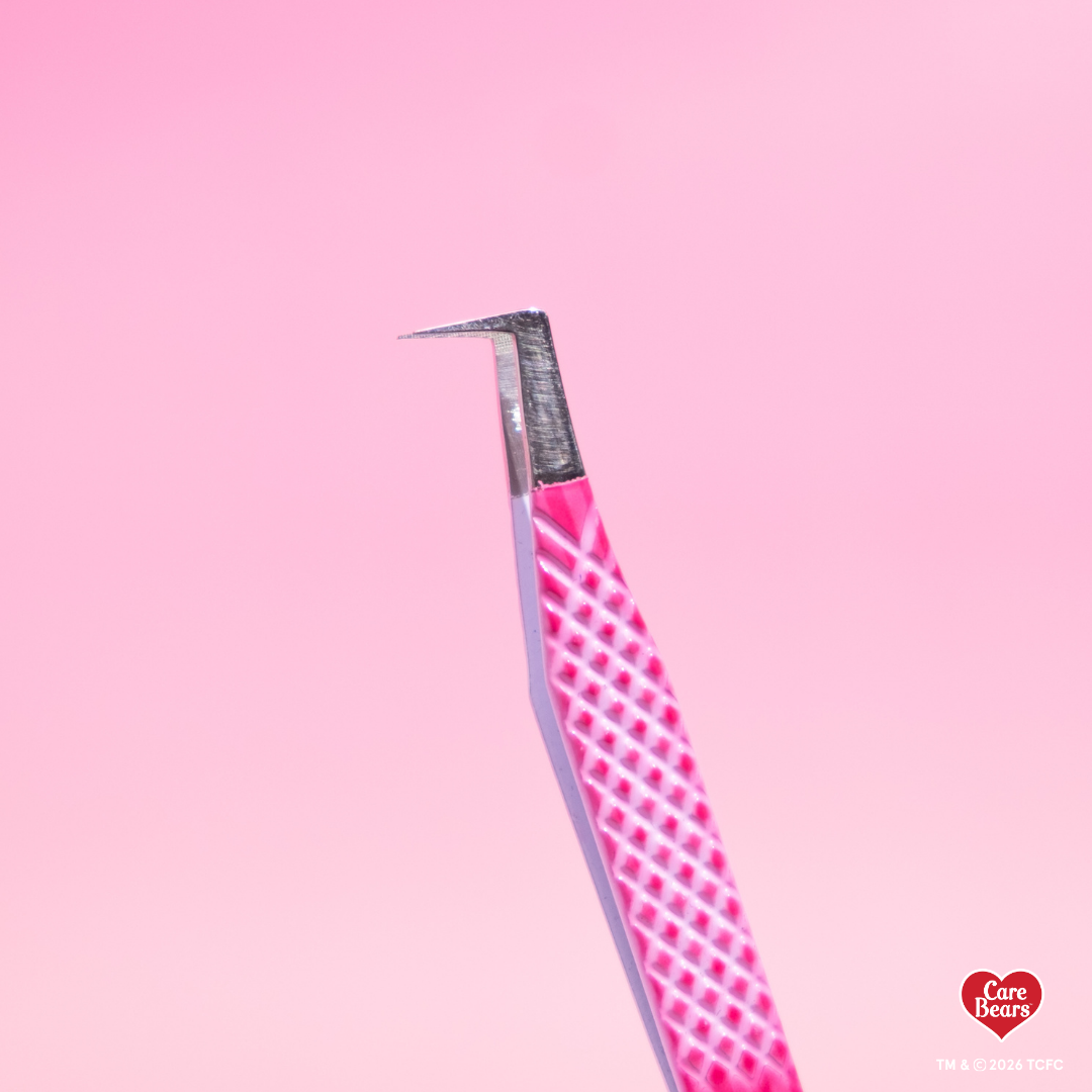 Élan Beauté x Care Bears pink volume tweezer featuring a textured grip and 90-degree angled tip, shown against a pink background.