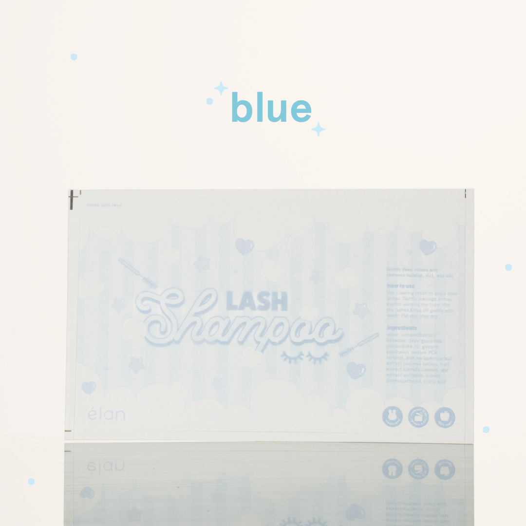 Blue lash shampoo label featuring a soft pastel bubble design, lash shampoo branding, usage instructions, ingredients, and product icons on a cream background.