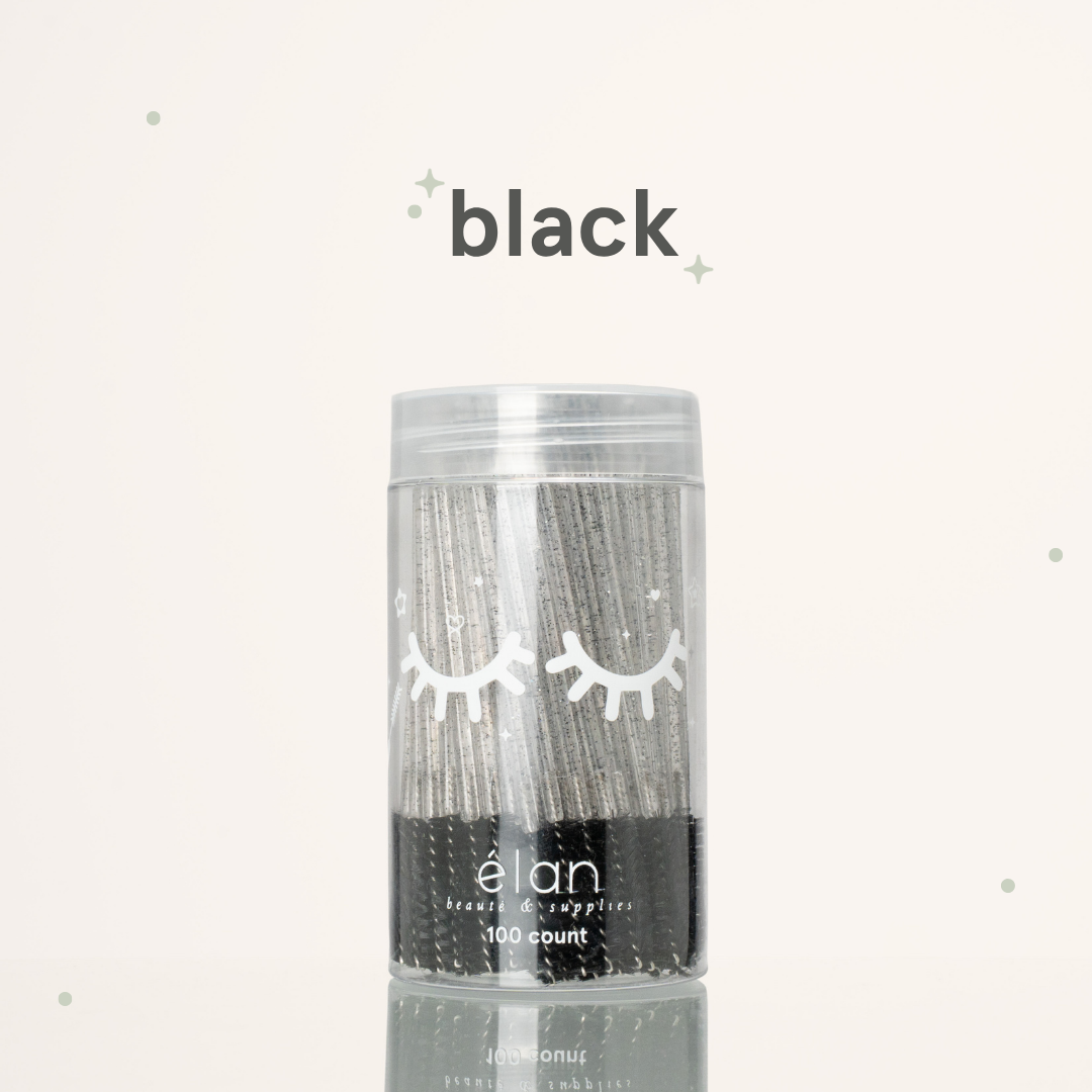 Élan Beauté black glitter spoolies in a clear 100-count container with white eyelash graphics, displayed on a soft cream background with black accents.
