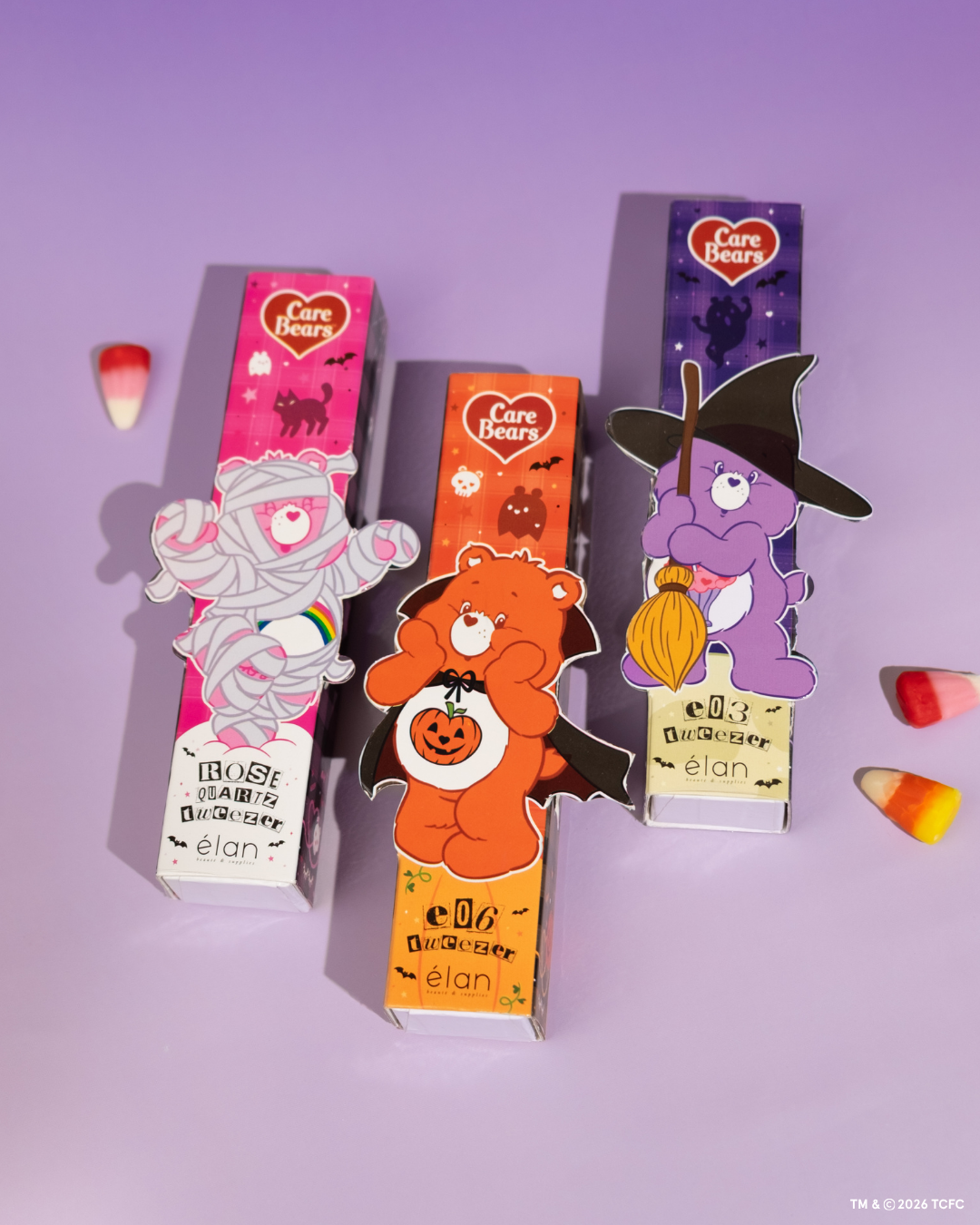 Élan Beauté x Care Bears Halloween tweezer collection featuring Rose Quartz, e06 curved isolation, and e03 volume tweezers in pink, orange, and purple character-themed packaging with candy corn accents.