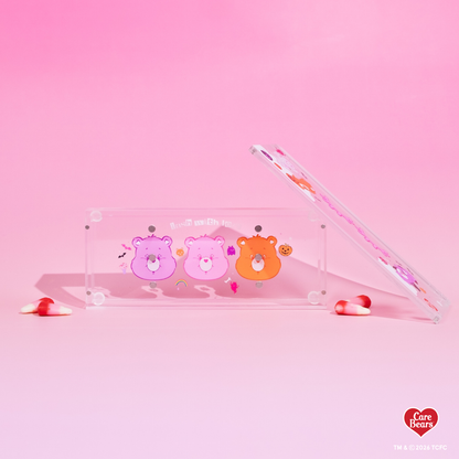 Élan Beauté x Care Bears Halloween magnetic tweezer case featuring pink, orange, and purple Care Bears character artwork with bats, pumpkins, spiderweb details, and candy corn accents.
